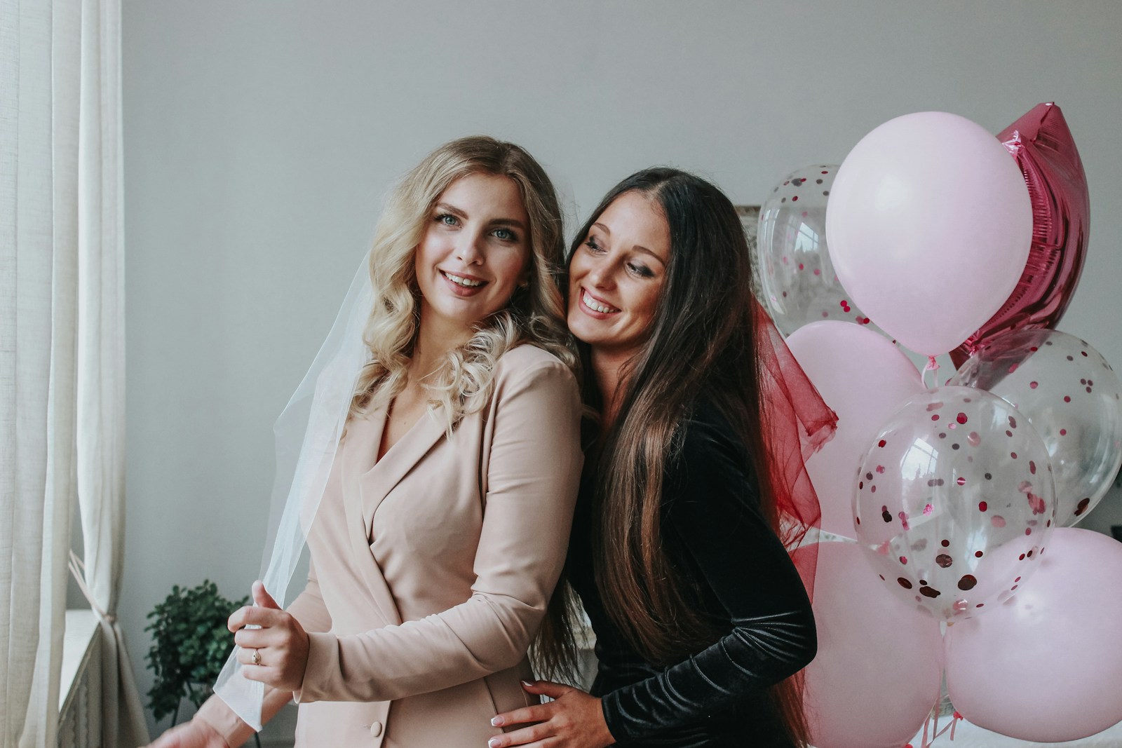 2 women smiling and standing beside each other