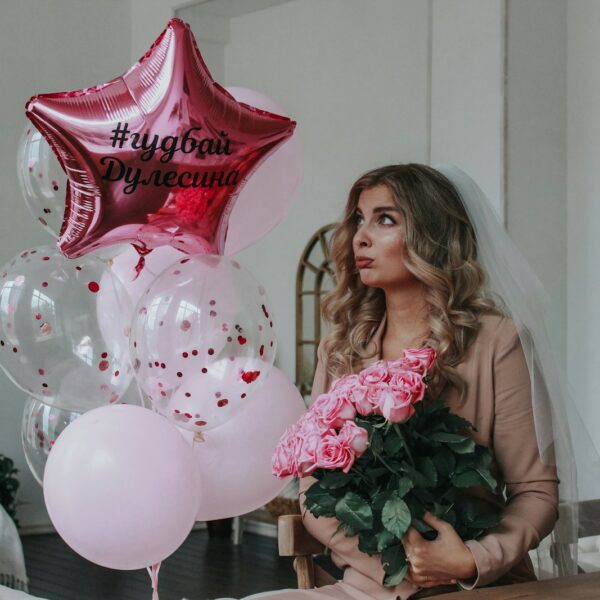 woman in pink dress holding bouquet of flowers